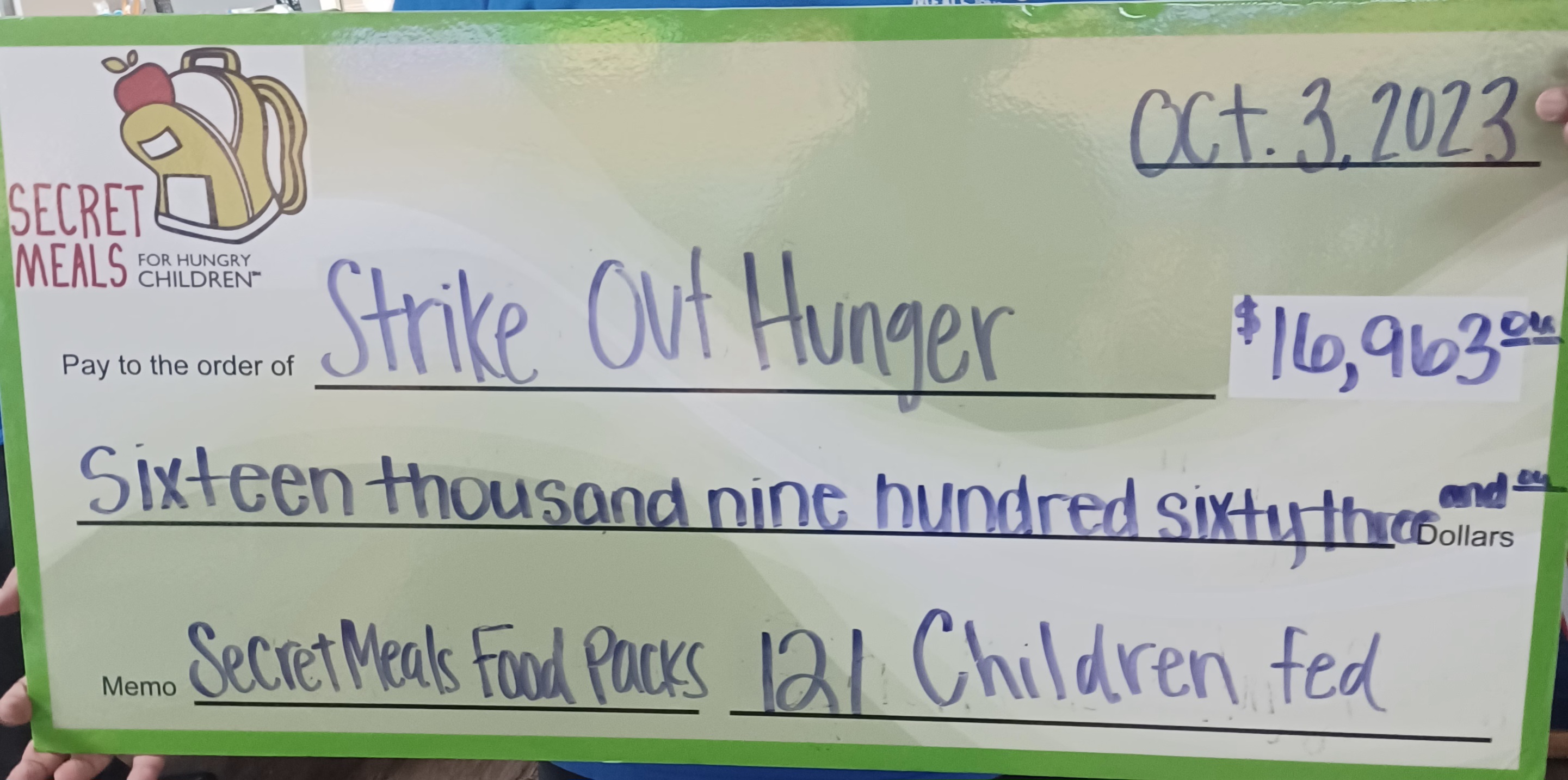 Promotional check. Strike Out Hunger. $16,963. 121 Children Fed.